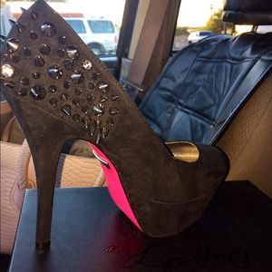 Studded black heels with pink bottom