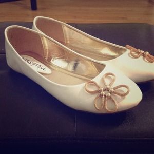 White ballet shoes with gold flower