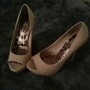 Tan open toe pumps.