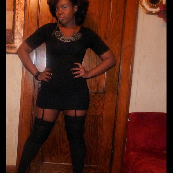 Black bodycon dress with jeweled accents.