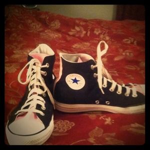 Pink and black Converse high tops