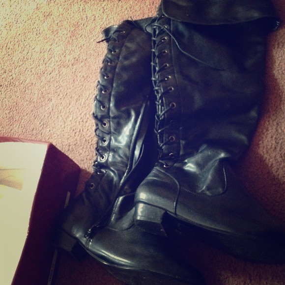 Black leather boots with ties up the back and heel