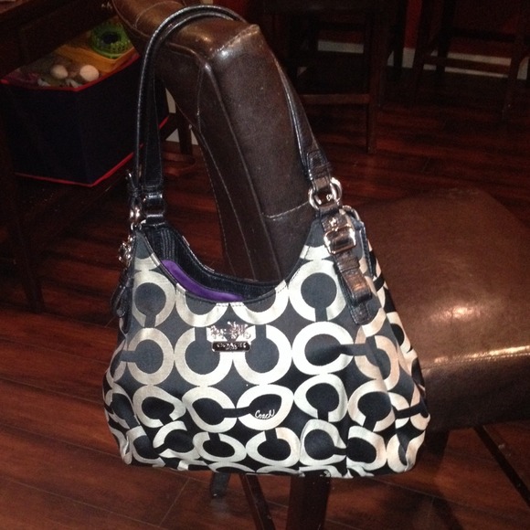 Coach purse with purple interior.
