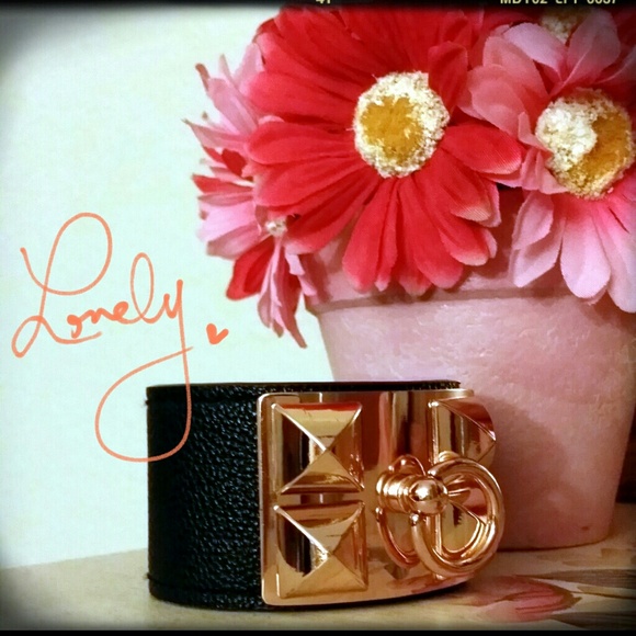 Black leather bracelet with gold studded plate