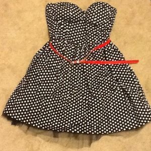 Black and white polka dot dress with red belt.