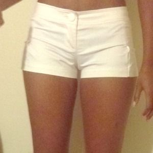 GUESS icy ivory shorts with pleat detail.