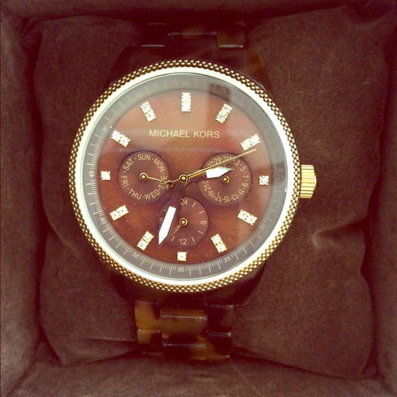 Michael Kors Watch and Apple iPhone headphones