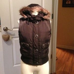 Black ski vest with fur trim hood.