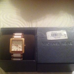 Michael kors watch has extra link box and tag .
