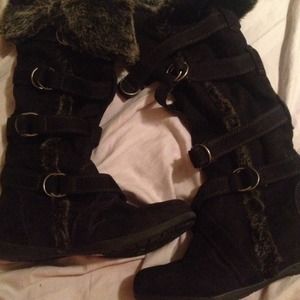 Black boots with fur trim and buckle detailing
