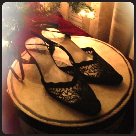 Black lace high heel shoes with ankle strap.