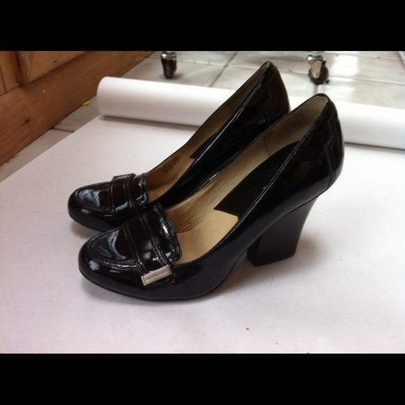 Michael Kors black patent leather heeled loafer.