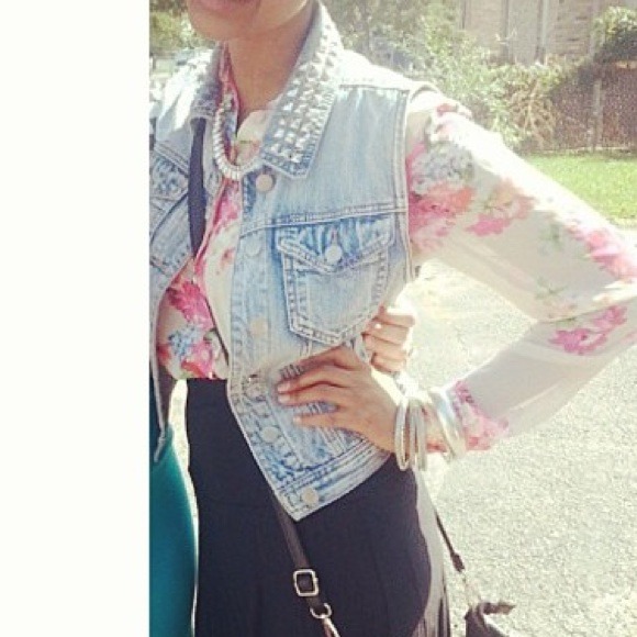 Studded jean sleeveless jacket.