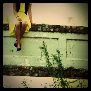 Yellow knee length dress. Longer in the back.