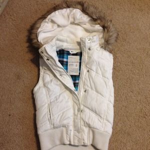 Padded vest with fur hood.