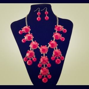 Red statement necklace with matching earrings.