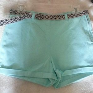Light aqua green shorts with gray belt