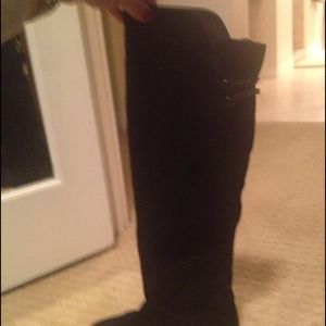 Black Steve Madden boots just above the knee