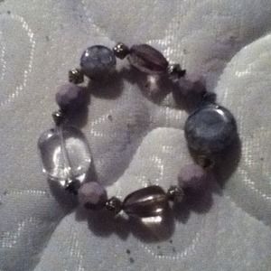 Bracelet with light purple beads on it.