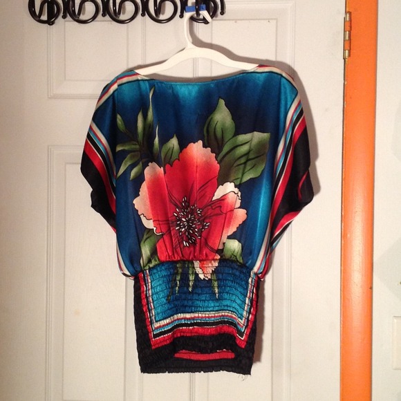 Flowered shirt. Slight run in the front.