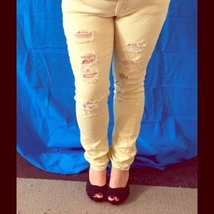 Yellow torn skinny jeans