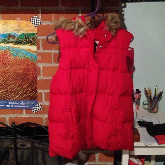 Red puffy vest with of fur collar