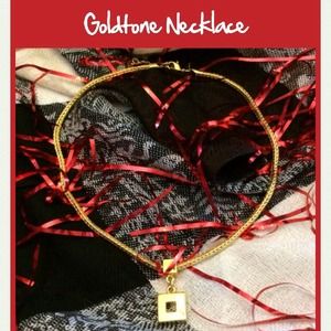 Dainty gold tone necklace. Pendant is about 1/2 in