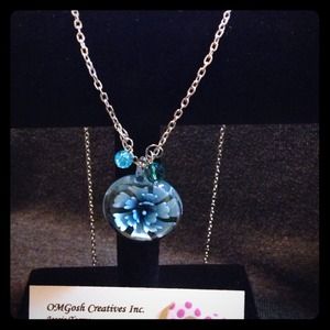 Beautiful flower in glass pendant with charms