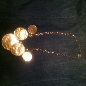 Gold necklace with gold pieces hanging down