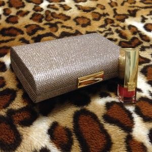 Gold holiday clutch with Estée Lauder lipstick