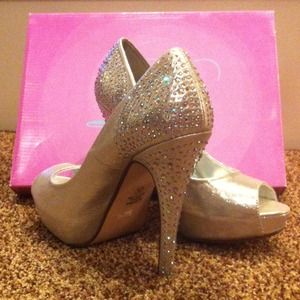 Silver platform heels with studs on heel.