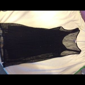 Black fishnet dress over black dress