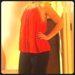 Red silk high-neckline shirt.