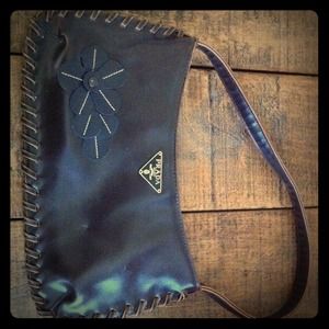 Purse with Prada tag on front.