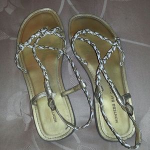Gold strappy gladiator sandals.