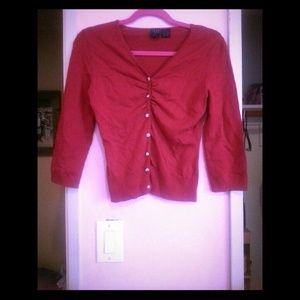 Red cardigan with cute little diamond buttons.