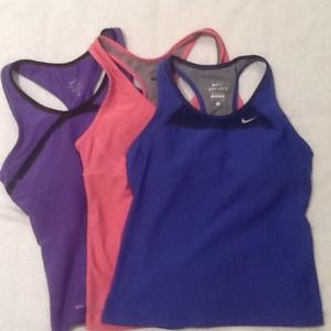 Bundle of three Nike Dri Fit workout tops.