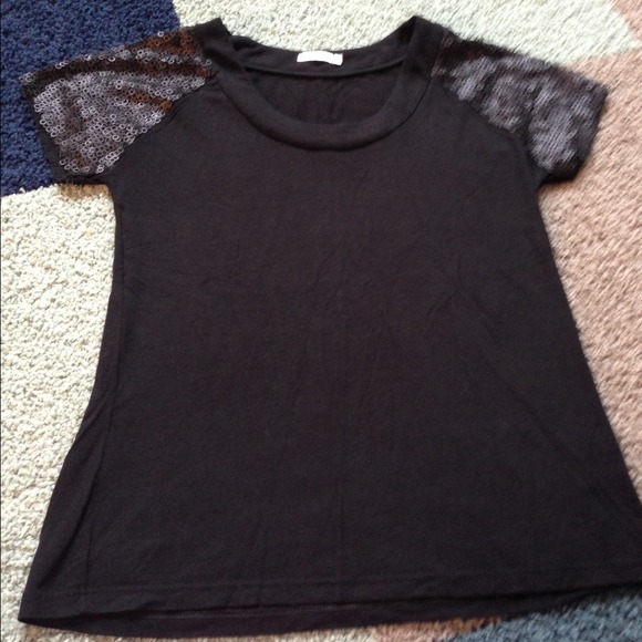 Black top with decorated arms