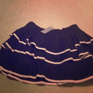 Black ruffly skirt with tan/white ribbon outline