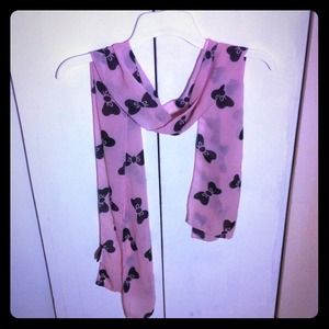 Baby pink scarf with black bows.