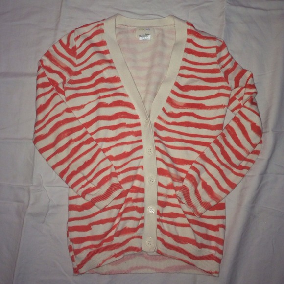 A beautiful cream and orange colored cardigan