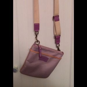Purple Coach cross body travel purse.