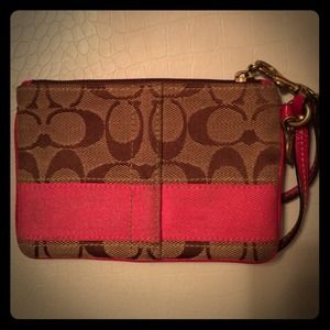 Tan and hot pink coach wristlet.