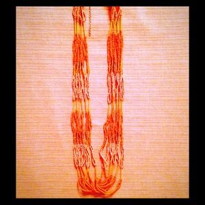 Orange pink and gold long necklace.