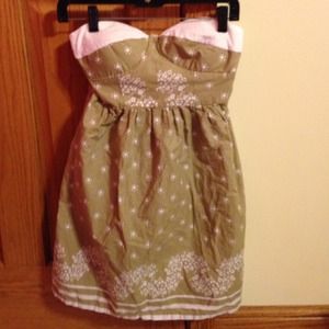 light tan summer dress with white floral designs.