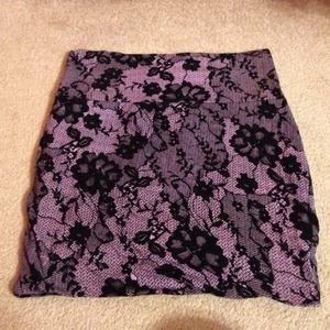 short purple miniskirt with black floral print.