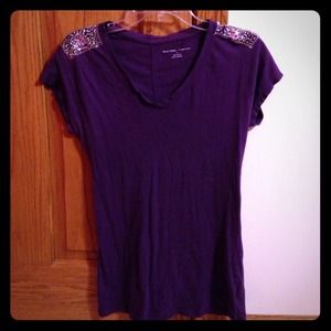 dark purple top with jeweled sleeves and v neck.