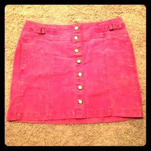 Pink skirt falls right above the knee