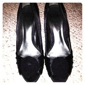 Black peep toe shoes with flower accents