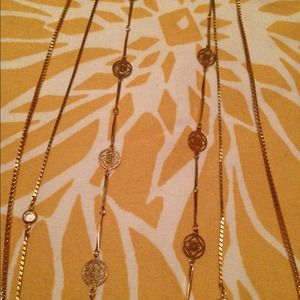 Three medium length thin gold necklaces